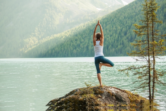yoga next to mountain lake